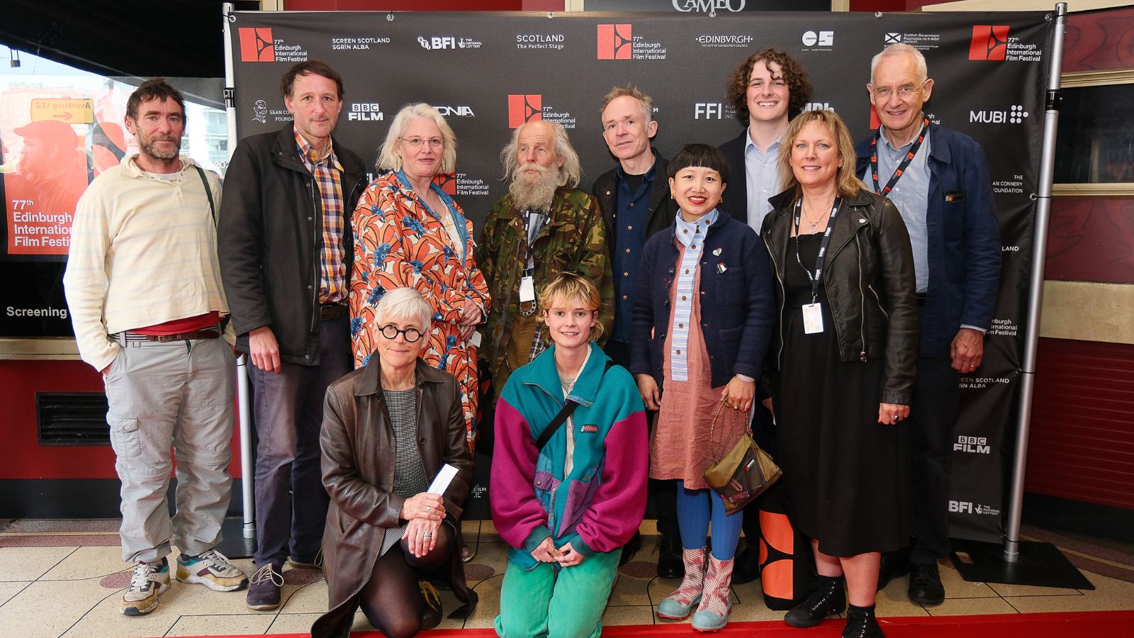 Jack Williams, Ben Rivers and other producers and crew at the Cameo Cinema in Edinburgh for the UK Premiere of Bogancloch. Jake wears a cammo jacket and brown trousers. Ben wears a black jacket and navy shirt.