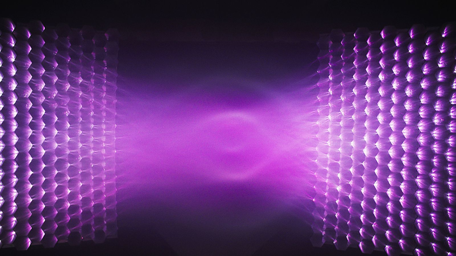 Still from Tracing Light, showing purple light waves shown on a black background.