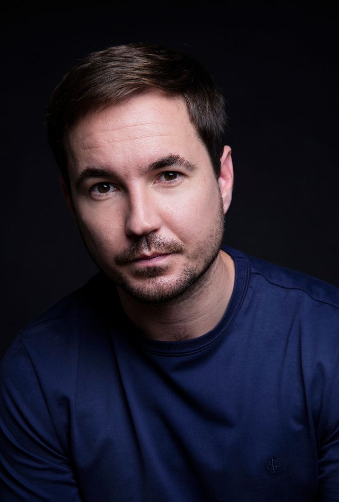 Headshot of actor Martin Compston, who wears a dark blue jumper.