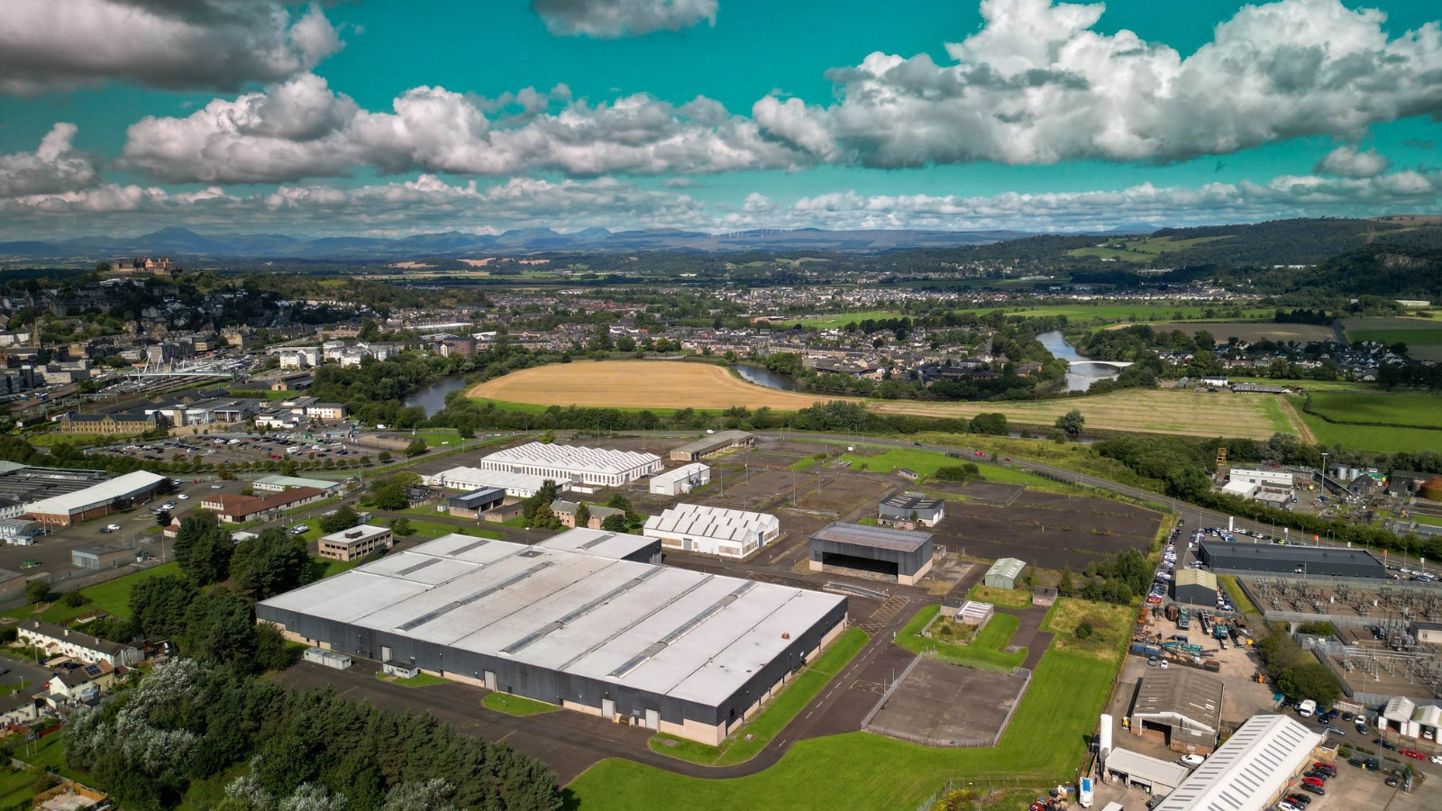 A drone shot of Stirling Studios location from above, showing a large building and fields surrounding it