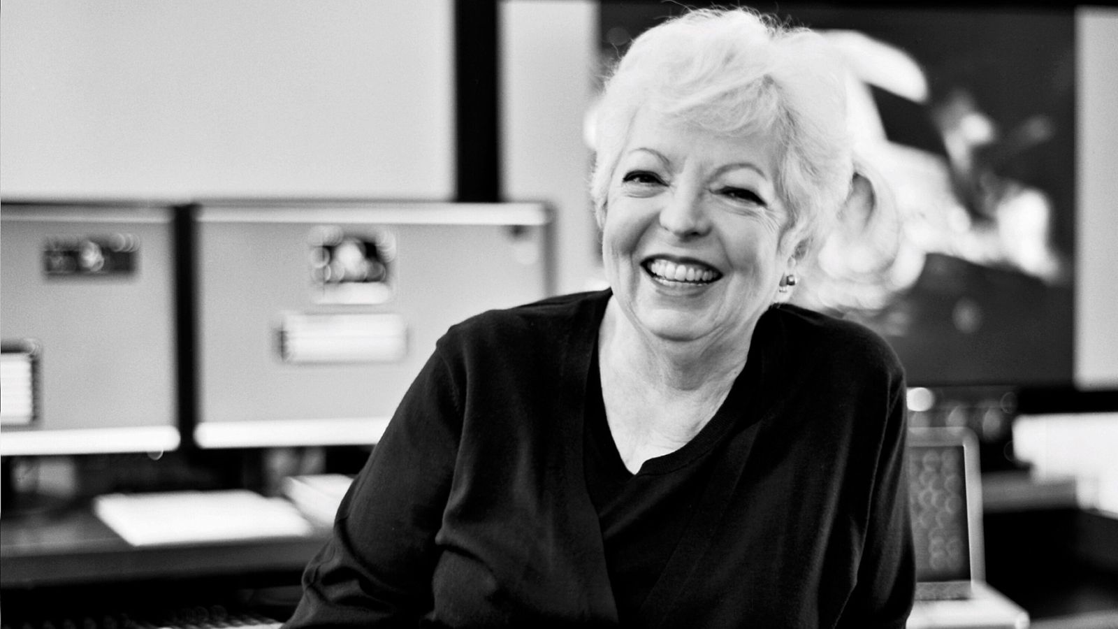 Black and white headshot for Thelma Schoonmaker. She wears a black top and smiles at the camera.